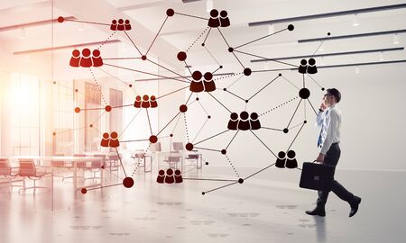 Elegant businessman in 3D office interior and social connection concept. Mixed mediaの写真素材