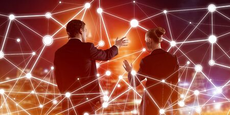 Businessman and businesswoman standing with back and touching connection conceptの写真素材