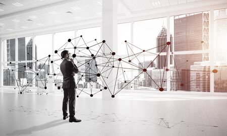 Elegant businessman in modern office interior and social connection concept. Mixed mediaの写真素材