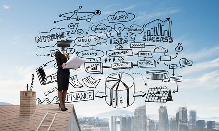 Faceless businesswoman with camera zoom instead of head standing on house roofの写真素材