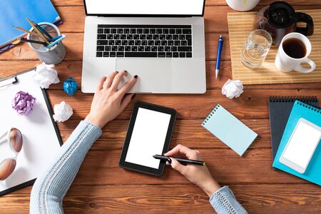 Businesswoman using tablet computer at office desk. Internet communication and commerce. Flat lay...