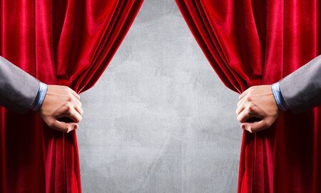 Close up of businessman hand open red velvet curtain. Place your textの写真素材