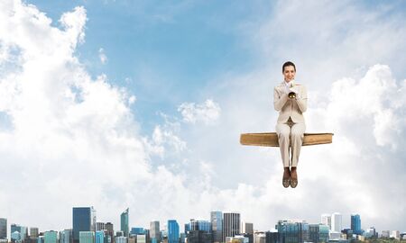 High school female student in business suit sitting on floating in air book. Musician with music...