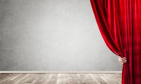 Close up of businessman hand open red velvet curtain. Place your textの写真素材