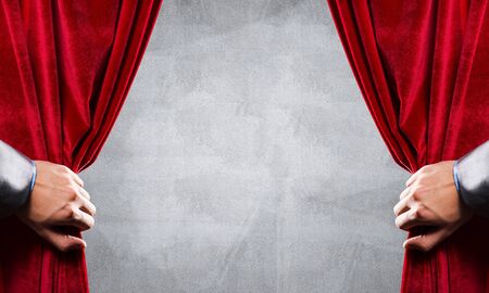 Close up of businessman hand open red velvet curtain. Place your textの写真素材