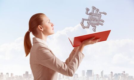 Woman holding open notebook with flying electronic circuit 3d model. Engineering and construction of...
