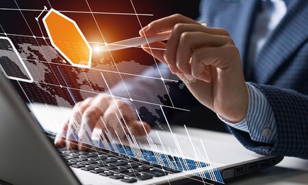Businessman works with financial data. Futuristic 3d interface above laptop computer. Interactive...