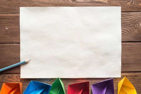White paper sheet and pencil on wooden table as concept for new ideaの写真素材