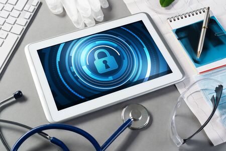 Doctors workplace with white tablet stethoscope and mask