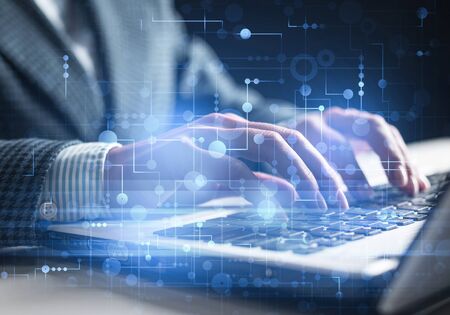 Project management and internet researching process. Man in business suit typing on laptop keyboard....