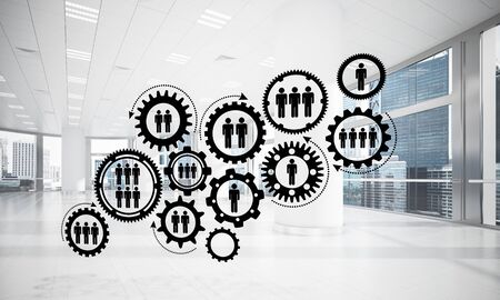 Cogwheels and gears mechanism as social communication concept in office interior. 3D renderingの写真素材