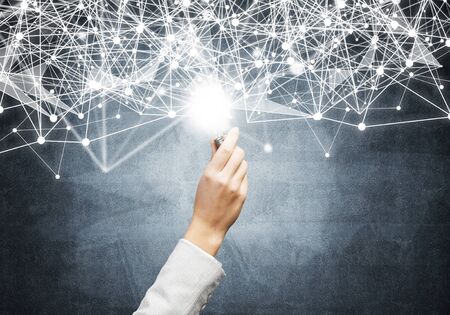 Human hand with glowing lamp and abstract digital network on background of dark wall. Professional business assistance and consulting service. Successful solution business motivation with light bulbの写真素材