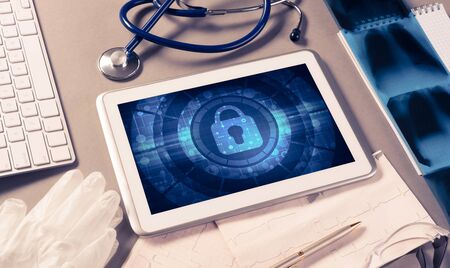 Doctors workplace with white tablet stethoscope and maskの写真素材