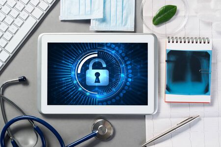 Doctors workplace with white tablet stethoscope and maskの写真素材