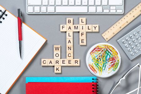 Business motivation concept with words from cubes. Still life of office workplace with crossword....