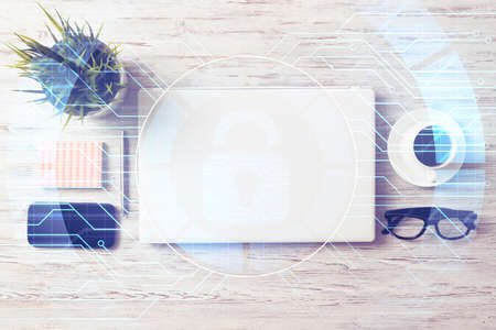 Closed laptop and other office stuff on wooden tableの写真素材