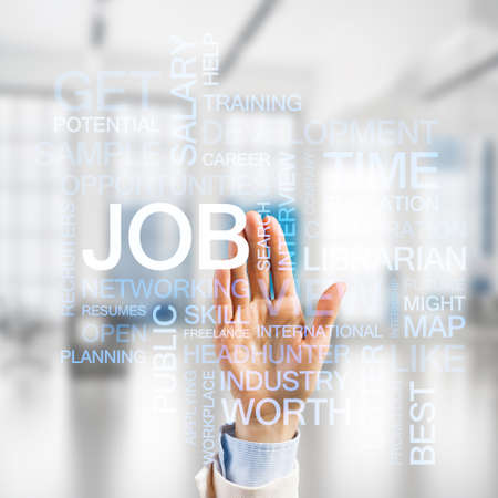 Close of businesswoman hand touching screen with business conceptual wordsの写真素材