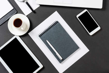 Top view of designer workplace with modern digital devices. Flat lay contemporary design with black...