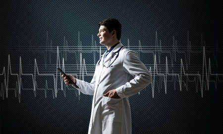 Doctor with tablet works with digital technologiesの写真素材