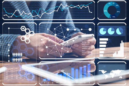 Businesswoman using mobile phone at desk. Close up woman hands and tablet computer. Mobile...