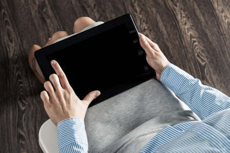 close-up of female hands with a computer tabletの写真素材