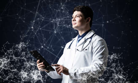 Doctor with tablet works with digital technologiesの写真素材