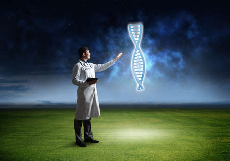 Doctor touches chromosome symbol, virtual technology in medicineの写真素材