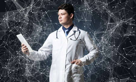 Doctor with tablet works with digital technologiesの写真素材