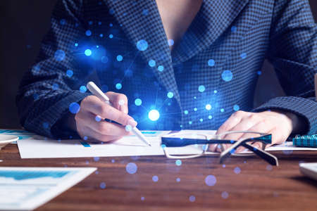 Investment manager analyze financial diagram at wooden desk. Close up woman hand with pen. Strategy...