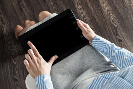 close-up of female hands with a computer tabletの写真素材