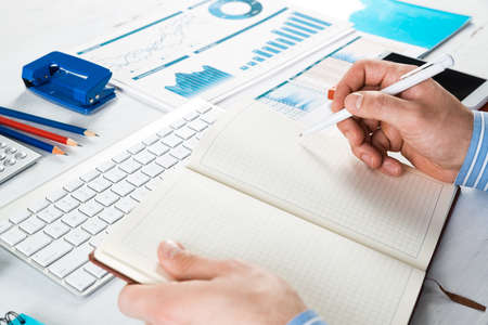 close-up of hands with notepad. office work