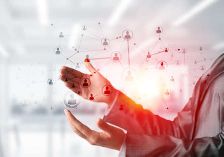 Closeup of business woman in suit keeping black social media network structure in hands. Office view...