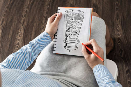 close-up, woman draws business notes in her notebook. Business Innovation Conceptの写真素材