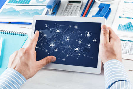 Mens hands hold a computer tablet. Social media concept