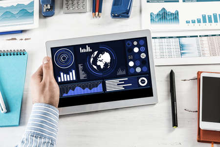 close-up, male hands with tablet. Businessman working at the table in office