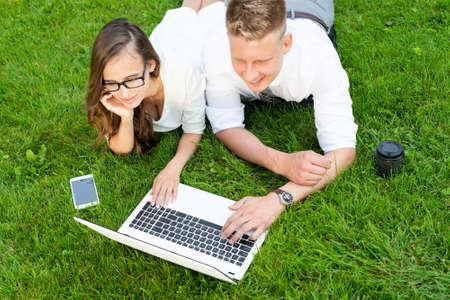 businessmen in the park with a laptop. create a project together