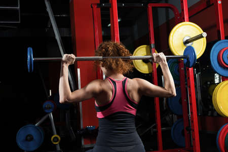 Woman bodybuilder engaged with a barbell in the gym. Healthy lifestyle.の写真素材