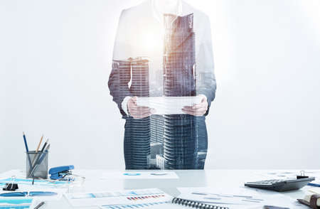 Businesswoman standing near office desk and using tablet computer. Banking and financial management. Corporate manager in suit working with online business analytics. Digital technology in businessの写真素材