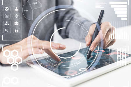 Businessman hands using tablet computer. Digital marketing media or financial diagrams in virtual...
