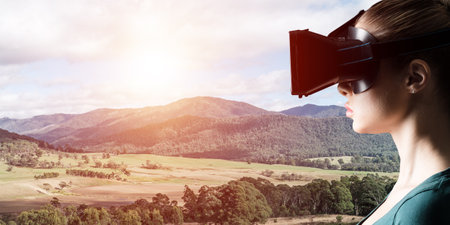 Young attractive woman in VR glasses. See nature through virtual realityの写真素材