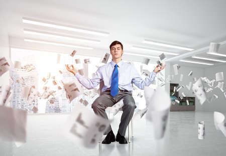 young businessman in the office meditates. concept of creativityの写真素材