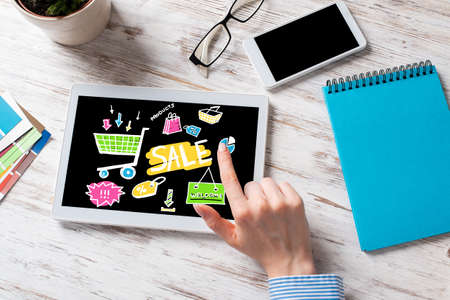 Business lady sitting at desk with tablet computer. Mobile smart devices in business processes. Business occupation and innovation. Corporate office workplace with business woman at wooden desk.の写真素材