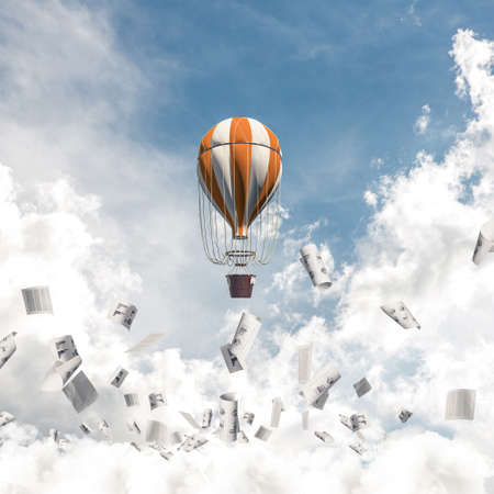 Colorful aerostat flying among paper documents and over the blue cloudy sky. 3D rendering.の写真素材