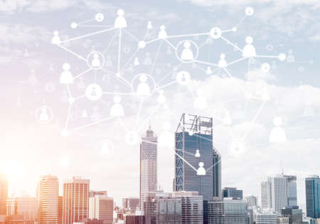 Modern cityscape with buildings and skyscrapers and social connection concept on screen