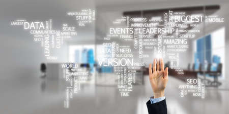 Close of businesswoman hand touching global business concept on screenの写真素材