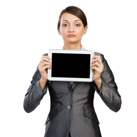 Businesswoman holding tablet computer with blank screen. Beautiful woman in business suit show...