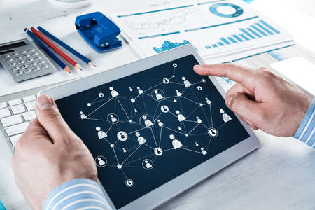 Mens hands hold a computer tablet. Social media concept