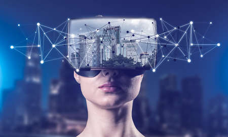 A young attractive woman looks at the cityscape through VR glasses.