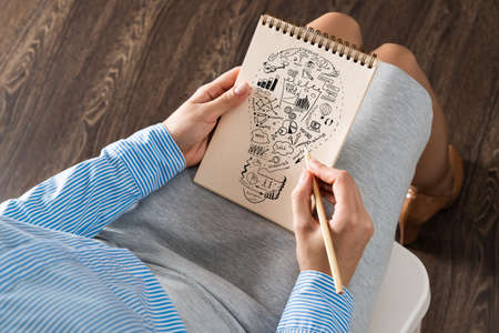 close-up, woman draws business notes in her notebook. Business Innovation Conceptの写真素材