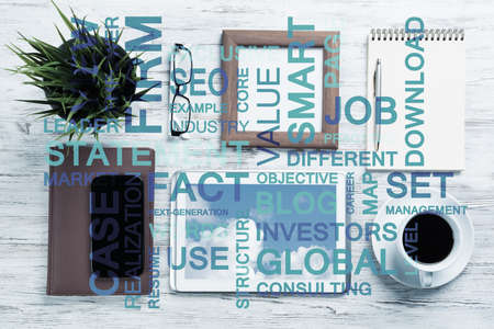 Top view of modern workplace with office stuff and business-related terms above presenting still office lifeの写真素材